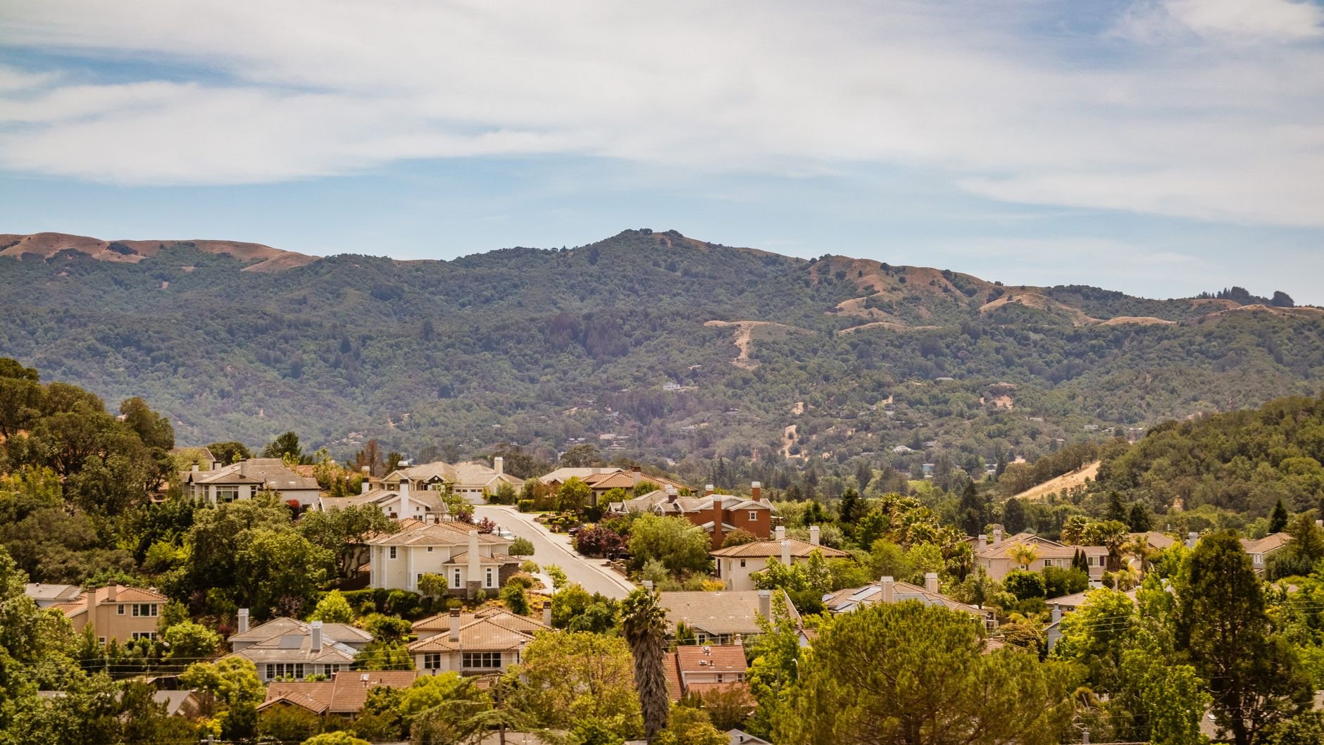 Beautiful suburban neighborhood with lush green hills in the Pacific Northwest.